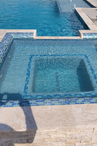 About_img_02 Pool jacuzzi with tile work.