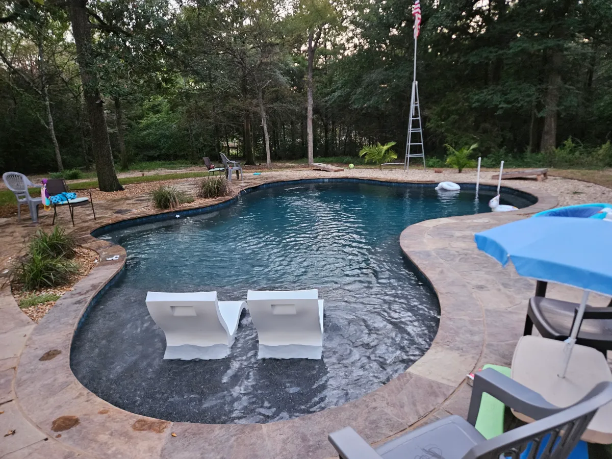 Pool completed with chairs.